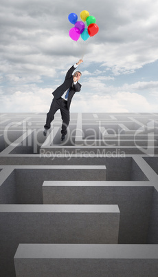 Composite image of businessman flying with balloons Composite image of businessman flying with balloons
