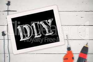 Diy against tools and tablet on wooden background