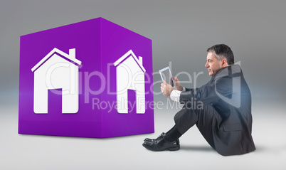 Composite image of mature businessman sitting using tablet