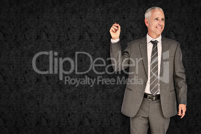 Composite image of businessman holding marker