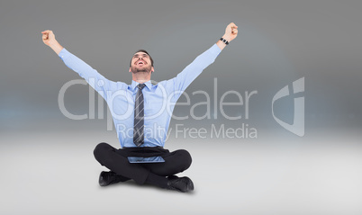 Composite image of businessman cheering with tablet sitting on f