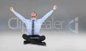 Composite image of businessman cheering with tablet sitting on f