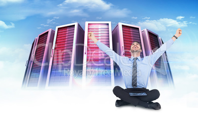 Composite image of businessman cheering with tablet sitting on f