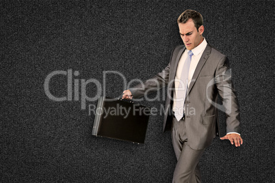 Composite image of businessman walking with his briefcase