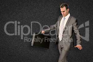 Composite image of businessman walking with his briefcase