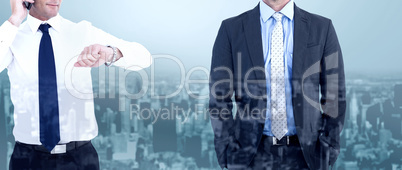 Composite image of businessman on the phone looking at his wrist