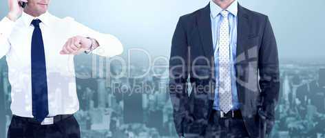 Composite image of businessman on the phone looking at his wrist