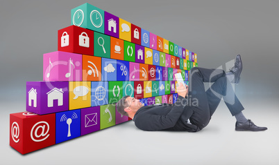 Composite image of businessman lying on the floor reading book Composite image of businessman lying on the floor reading book