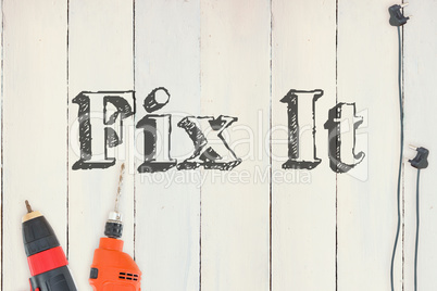 Fix it against diy tools on wooden background