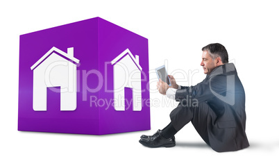 Composite image of mature businessman sitting using tablet