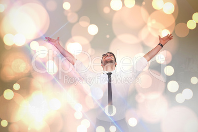 Composite image of cheering businessman with his arms raised up