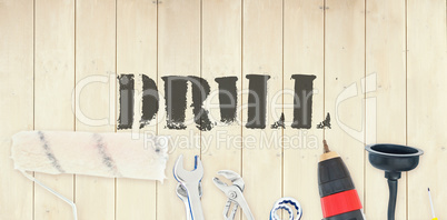 Drill against diy tools on wooden background