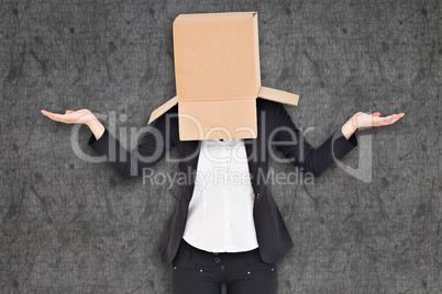 Composite image of businesswoman with box over head