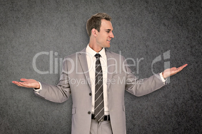 Composite image of businessman with hands out