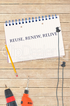 Reuse, renew, relive against tools and notepad on wooden backgro