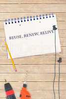 Reuse, renew, relive against tools and notepad on wooden backgro