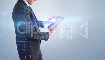 Composite image of businessman standing while using a tablet pc