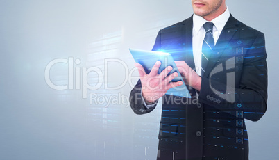 Composite image of unsmiling businessman using tablet pc