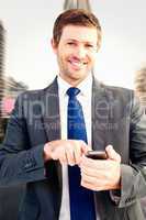 Composite image of businessman sending a text message