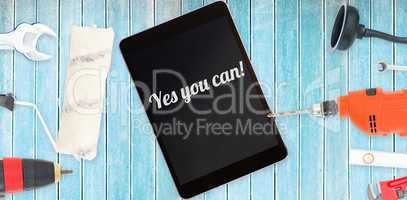 Yes you can! against tools and tablet on wooden background