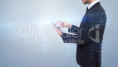 Composite image of concentrated businessman touching his tablet