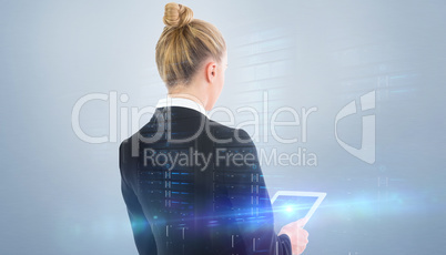 Composite image of businesswoman holding tablet