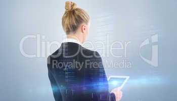 Composite image of businesswoman holding tablet