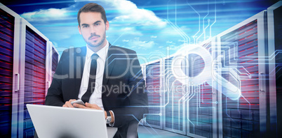 Composite image of cheerful businessman with laptop using smartp