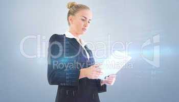 Composite image of businesswoman holding tablet