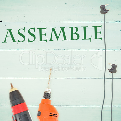 Assemble against tools on wooden background