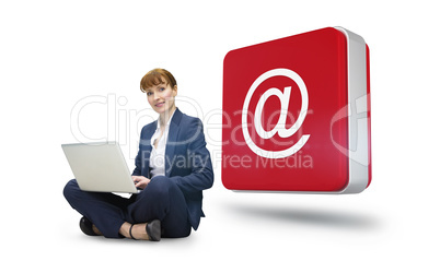 Composite image of businesswoman using laptop