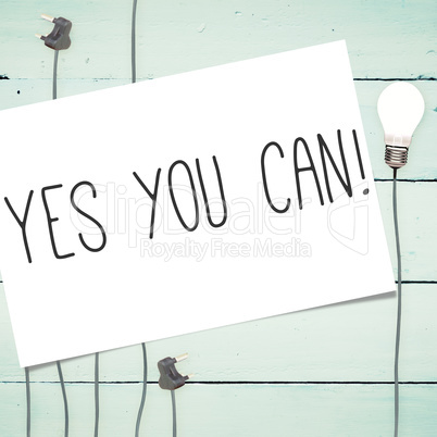 Yes you can! against light bulbs on wooden background