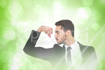 Composite image of cheerful businessman tensing arm muscle
