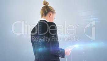 Composite image of businesswoman holding tablet