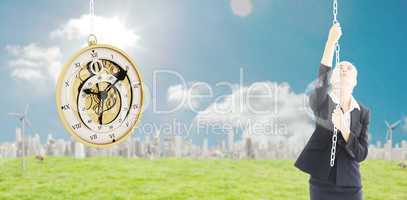 Composite image of businesswoman pulling a chain