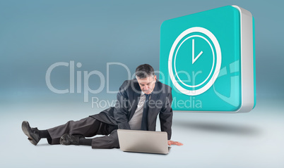 Composite image of mature businessman sitting using laptop