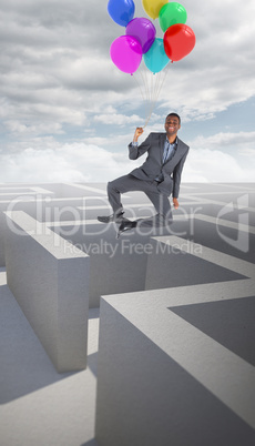 Composite image of businessman flying with balloons