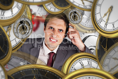 Composite image of thinking businessman scratching head