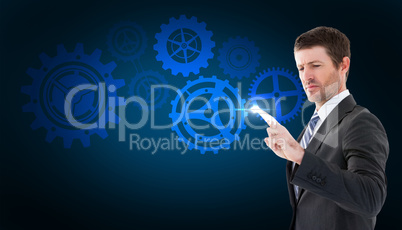 Composite image of businessman standing and pointing the finger