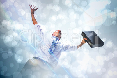 Composite image of businessman holding briefcase and cheering