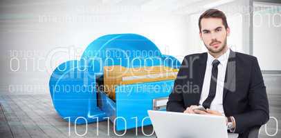 Composite image of cheerful businessman with laptop using smartp