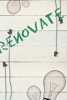 Renovate  against bulb on wooden background
