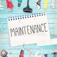 Maintenance  against tools and notepad on wooden background