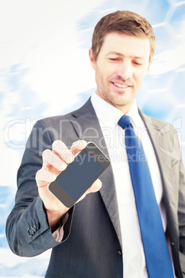 Composite image of businessman showing his smartphone screen