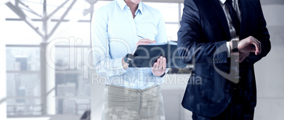 Composite image of handsome businessman checking the time