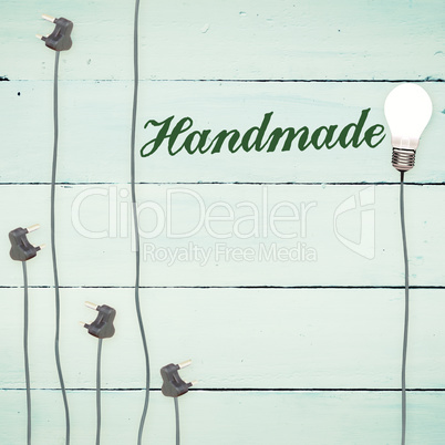 Handmade against light bulbs on wooden background