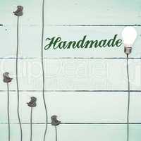 Handmade against light bulbs on wooden background