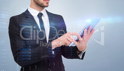 Composite image of mid section of a businessman using digital ta