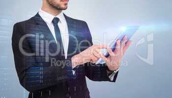 Composite image of mid section of a businessman using digital ta