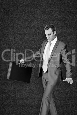 Composite image of businessman walking with his briefcase